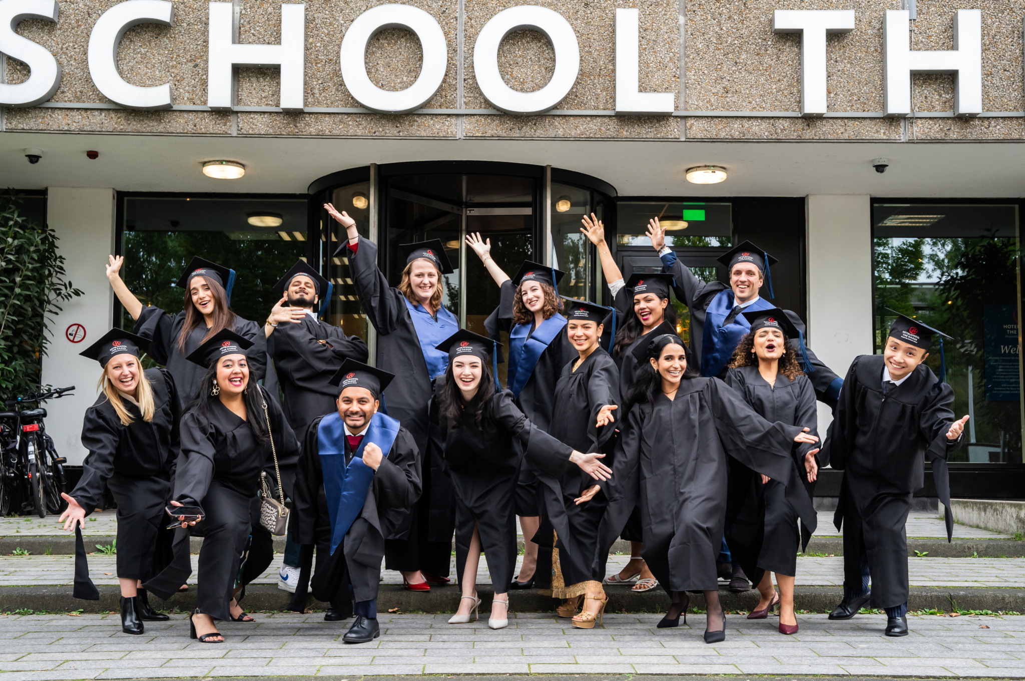 Students in their graduation gown in front of Campus Amsterdam entrance