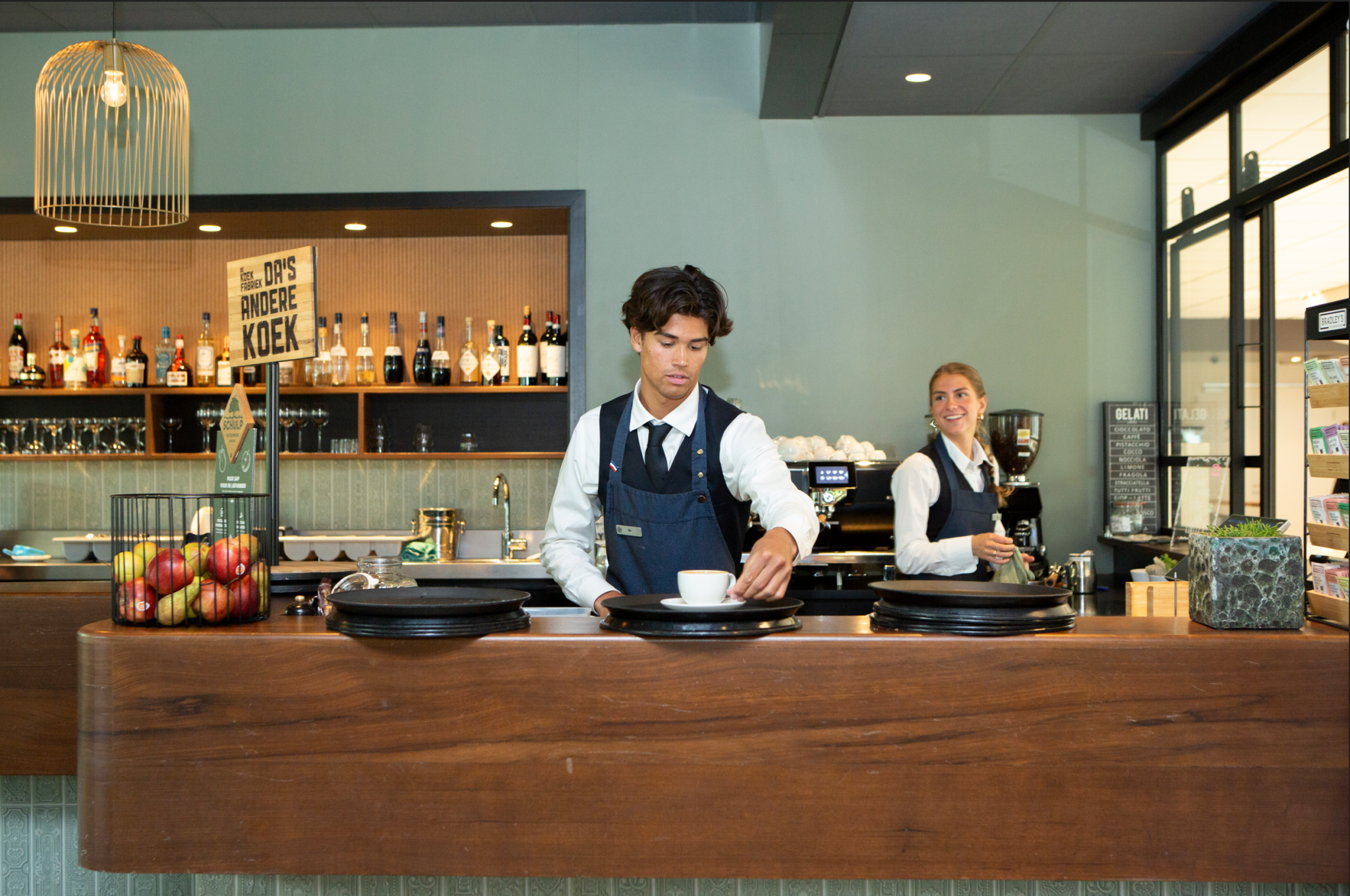 Students behind the bar preparing coffees